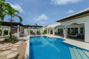 a swimming pool in the backyard of a house at Orchid Paradise Homes 404 in Hua Hin