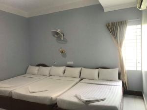 מיטה או מיטות בחדר ב-KampongBay Makeng II Guesthouse