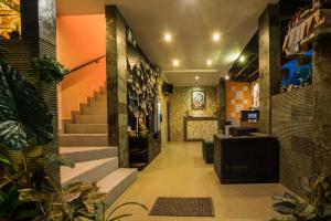 a lobby with a staircase and a stair case at Griya Tunjung Sari in Denpasar