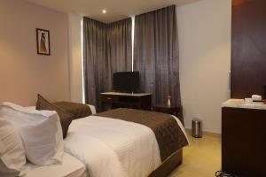 Postel nebo postele na pokoji v ubytování Visthara inn - Comfort Stay
