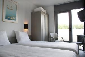 Ένα ή περισσότερα κρεβάτια σε δωμάτιο στο Fletcher Hotel - Restaurant Nieuwvliet Bad