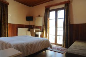 Postel nebo postele na pokoji v ubytování Hotel Olympic