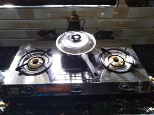 a stove with a tea pot on top of it at Lionka Guesthouse in Mirissa
