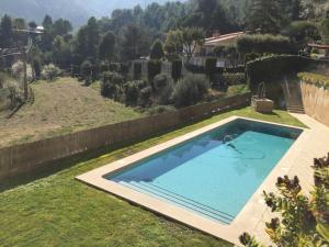 a swimming pool in the yard of a house at Montserrat La Calsina in Monistrol
