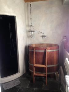 a wooden tub in a bathroom with a sink at BLAUWE HOORN in Amsterdam