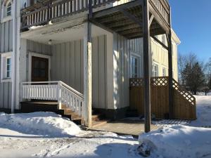 a porch of a house in the snow at Anki's apartment in Haparanda