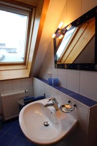 a bathroom with a sink and a mirror at Ferienwohnungen Panoramablick in Bernau im Schwarzwald +50 photos