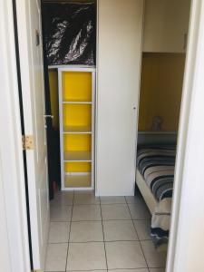 a room with a closet with yellow and white cabinets at Casinostraat 16/67 in Blankenberge