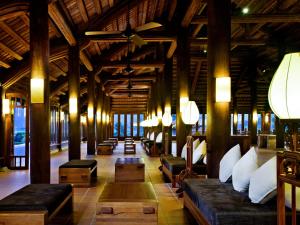 a lobby with couches and tables in a building at Emeralda Resort Ninh Binh in Ninh Binh