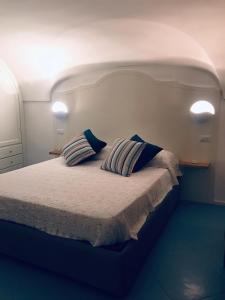 a bedroom with a bed with two pillows on it at Arco della Rua in Amalfi