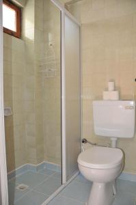 a bathroom with a toilet and a shower at Hotel Royal in Alanya