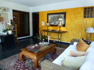 a living room with a couch and a coffee table at FIGTREE GUESTHOUSE in Maputo