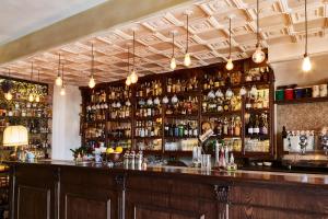 a bar with a lot of bottles of alcohol at Il Viaggiatore Gaeta Medievale B&B in Gaeta
