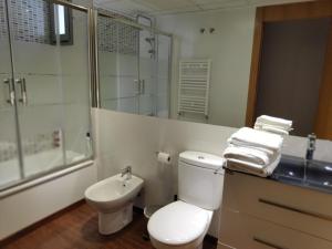 a bathroom with a toilet and a sink and a shower at Cartagena Centro in Cartagena +30 photos