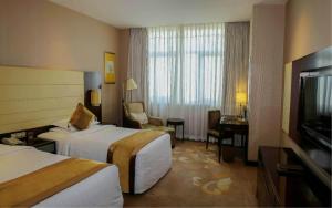 Postel nebo postele na pokoji v ubytování Ritan Hotel Downtown Beijing
