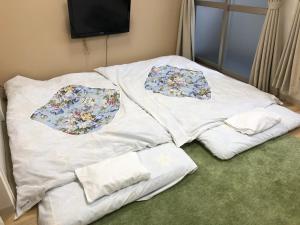 Postel nebo postele na pokoji v ubytování Hotel Mirai