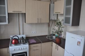 a kitchen with a tea kettle on a stove at Apartments Theatre Shepkina 2 room in Sumy