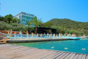 a pool with chairs and umbrellas in a resort at La Moda Beach Hotel in Kaş