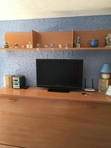 a television sitting on top of a wooden desk at Denia Playa II in Denia