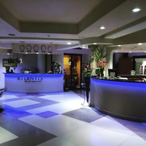 a lobby of a restaurant with a counter with flowers at Atlantis Palace Hotel in Mascali