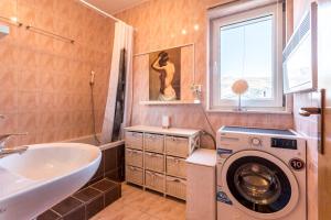 a bathroom with a washing machine and a sink at Apartment M&M in Split