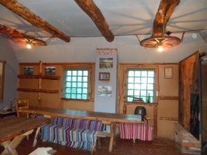 a room with a wooden table and some windows at Viruna Farm in Kiraste