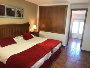 
a bedroom with a large bed and a large window at Hotel Patri in Huéscar
