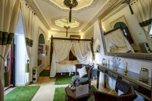 a bedroom with a bed and a large mirror at Riad Anabel in Marrakesh