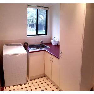a small kitchen with a sink and a window at Addies Place Goolwa in Goolwa