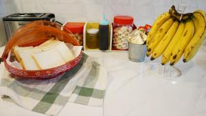 a counter with a bag of cheese and bananas on it at Silla House in Hat Yai