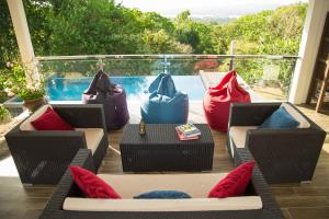 a patio with chairs and a table and a pool at Ranis Lodge in Kampung Padang Masirat
