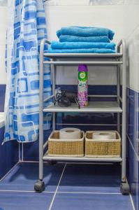 a towel rack in a bathroom with towels at Rooms and Apartment Veral-KA in Karlovac