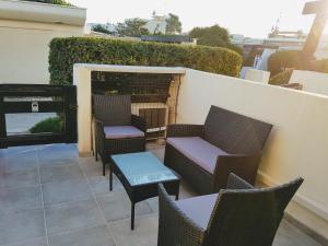 a group of chairs and tables on a patio at Naturist Village Studio Port Nature in Cap d'Agde