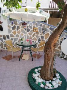 a table next to a tree in a patio at Calle Dr Fleming 3 bedroom home in San Javier