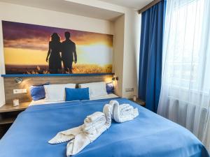 A bed or beds in a room at Hotel Familia