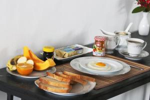 a breakfast tray with eggs and bread and fruit at Hiranya Mountain View Hostel Kandy in Kandy +55 photos