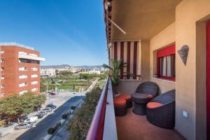 a balcony with furniture and a view of a street at WintowinRentals Parque Litoral, Family & Málaga in Málaga