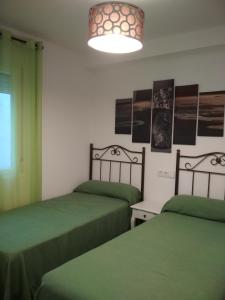 Posteľ alebo postele v izbe v ubytovaní APARTAMENTOS LA VEREDA