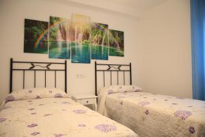 Posteľ alebo postele v izbe v ubytovaní APARTAMENTOS LA VEREDA