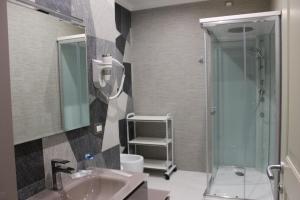 a bathroom with a shower and a sink and a toilet at Madigans rooms bed&breakfast in Lecce +48 photos