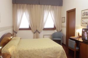 Postel nebo postele na pokoji v ubytování Hotel Sagittario