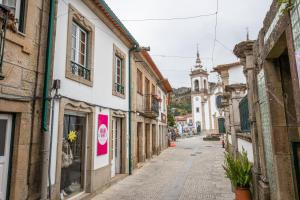 an empty street in an old town with buildings at A casa do cervo in Vila Nova de Cerveira