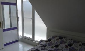 a bedroom with a bed next to a window at Apartment Sagittarius in Kyustendil