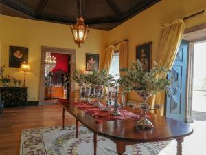 a dining room with a table with flowers on it at Casa de Quintã in Marco de Canaveses