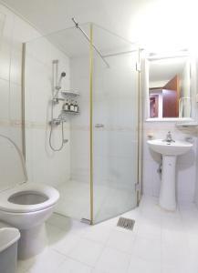 a bathroom with a shower and a toilet and a sink at Dolma Hongdae in Seoul +37 photos