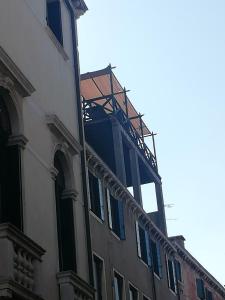a building with scaffolding on the side of it at Cà Mocenigo Terrace in Venice