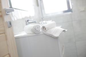 a bathroom with two rolls of towels on a sink at Casa Vacanze Sopravento in Porto Cesareo