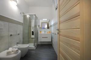 a bathroom with a sink and a toilet and a shower at Casa Vacanze Sopravento in Porto Cesareo