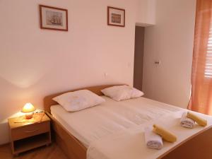 Posteľ alebo postele v izbe v ubytovaní Apartments Kuzman