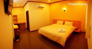 سرير أو أسرّة في غرفة في Baan Tawan Shine Surin